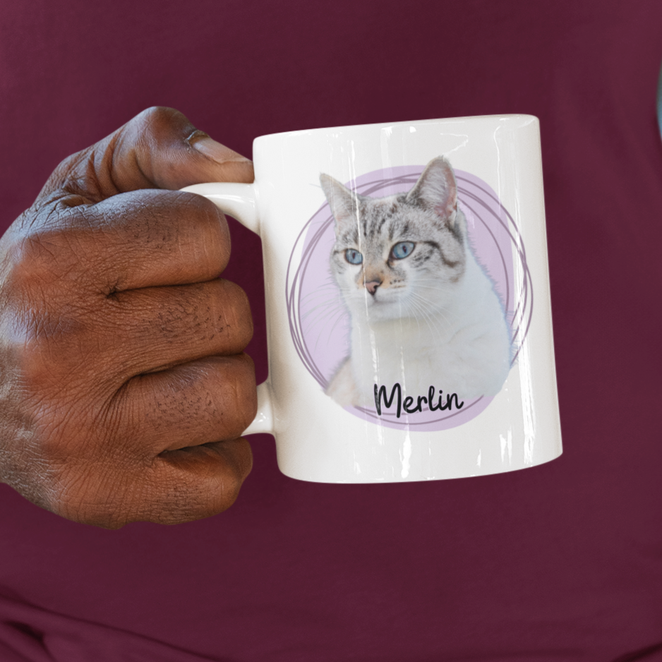 Man holding a mug with a design on it