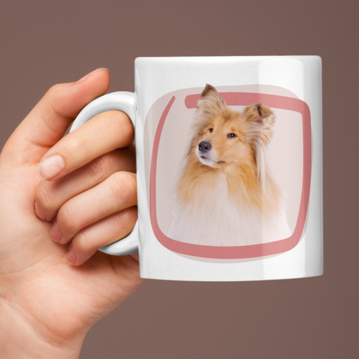 Person holding a mug with a dog illustration on a brown background