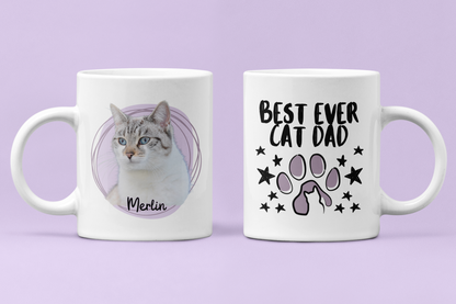 Two white mugs with a cat-themed design on a purple background
